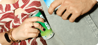 Hands holding SIX6R cans
