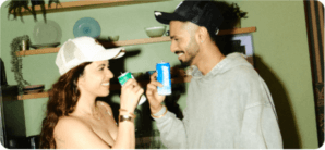 Karan and Rashi toasting with SIX6R cans