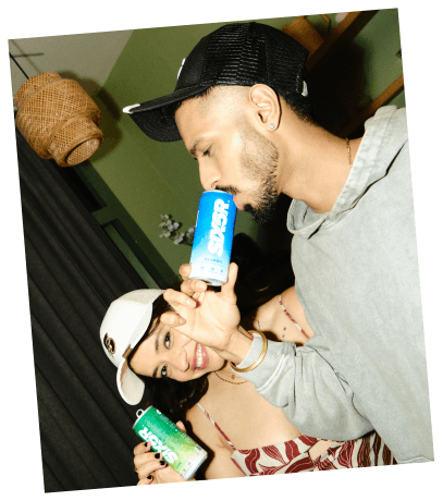 Close-up of Karan and Rashi holding SIX6R cans
